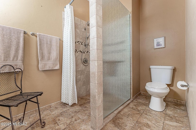 bathroom featuring toilet and a shower with shower curtain