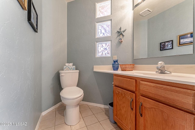 bathroom featuring tile patterned flooring, vanity, and toilet