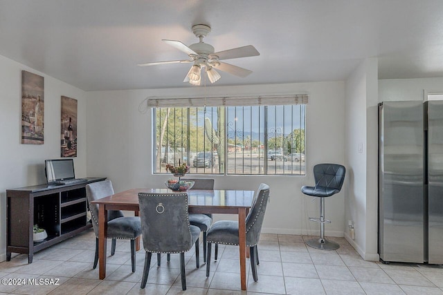 dining space with ceiling fan and light tile patterned floors