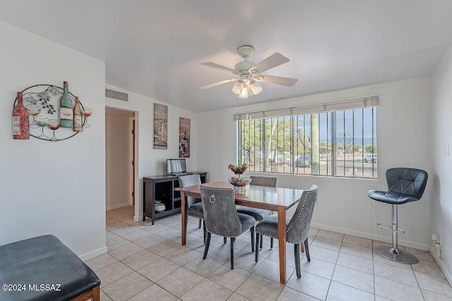 tiled dining area with ceiling fan