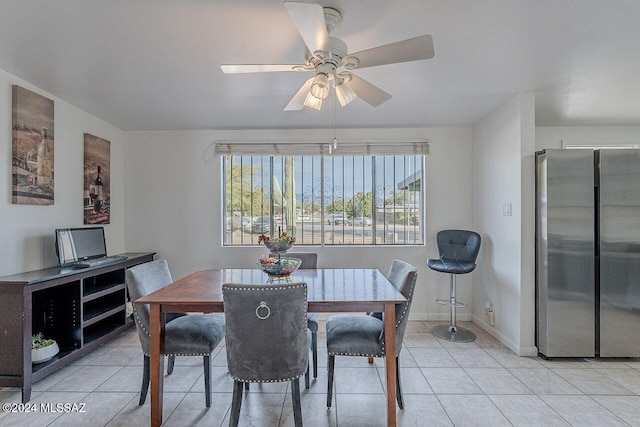 tiled dining area featuring ceiling fan