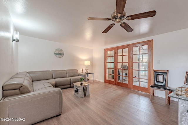 living room with ceiling fan, french doors, and light hardwood / wood-style floors