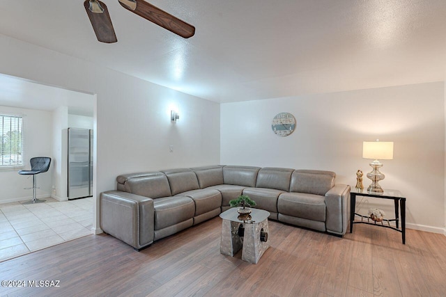 living room featuring ceiling fan and light wood-type flooring