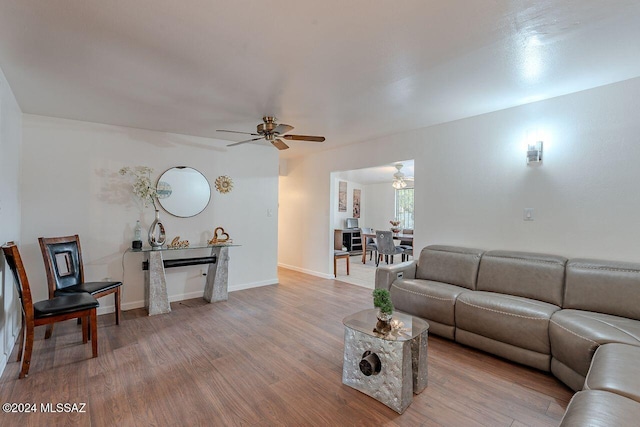 living room featuring ceiling fan and hardwood / wood-style floors