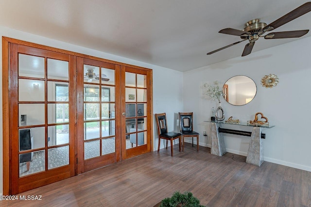 living area featuring ceiling fan, french doors, and dark hardwood / wood-style floors