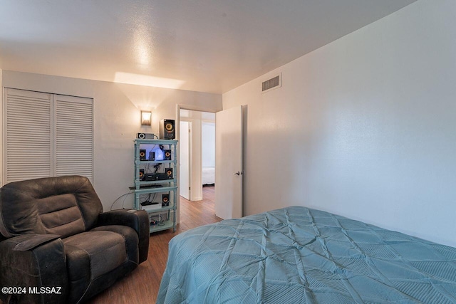 bedroom featuring wood-type flooring and a closet