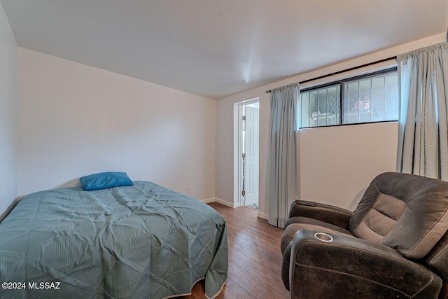 bedroom with wood-type flooring