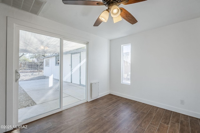 empty room featuring ceiling fan and dark hardwood / wood-style flooring