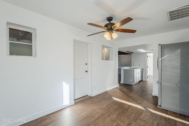 interior space featuring sink, dark wood-type flooring, and ceiling fan