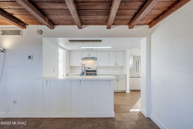 kitchen featuring stainless steel range oven, wood ceiling, fridge, kitchen peninsula, and white cabinets