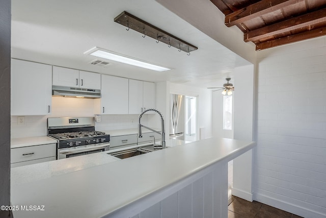 kitchen featuring sink, stainless steel appliances, white cabinets, wooden ceiling, and beamed ceiling