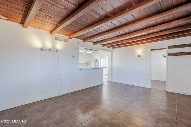 interior space with beamed ceiling, tile patterned floors, and wood ceiling