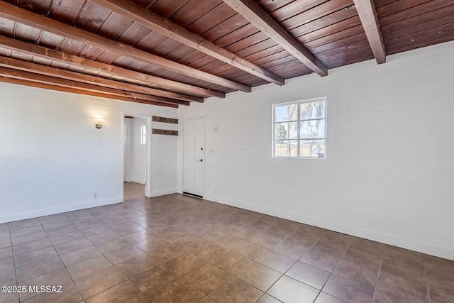 tiled empty room with wood ceiling, brick wall, and beamed ceiling