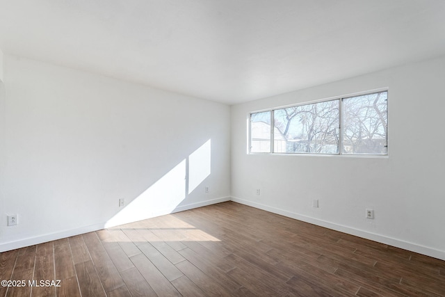 empty room featuring dark hardwood / wood-style flooring