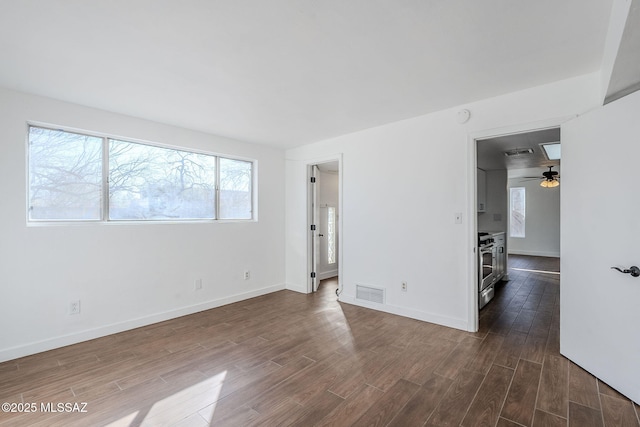 spare room with dark wood-type flooring and ceiling fan