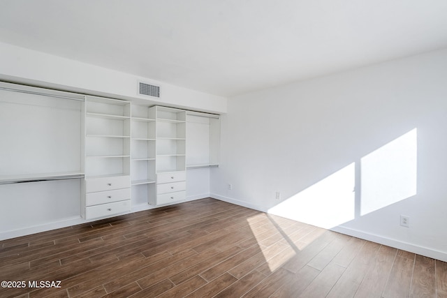 unfurnished bedroom featuring dark hardwood / wood-style flooring and a closet