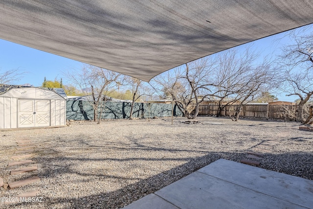 view of yard with a storage unit and a patio