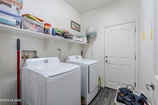 washroom featuring dark hardwood / wood-style floors and washing machine and dryer