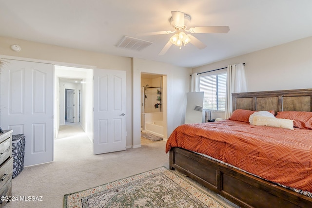 carpeted bedroom with ceiling fan and ensuite bath