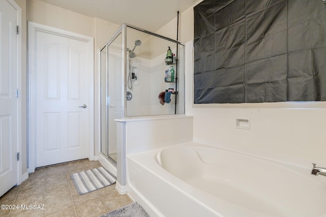 bathroom with tile patterned floors and independent shower and bath