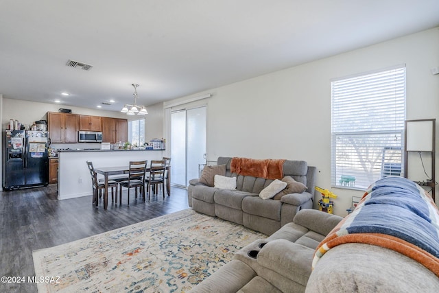 living room featuring dark hardwood / wood-style floors and a healthy amount of sunlight