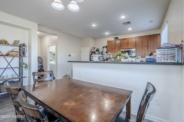 dining area featuring dark hardwood / wood-style floors