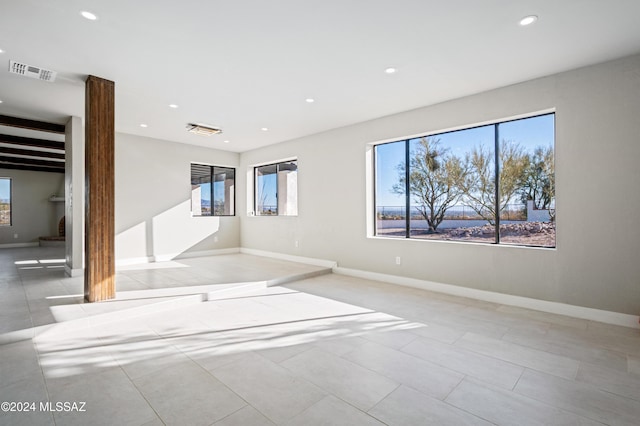 spare room with beam ceiling