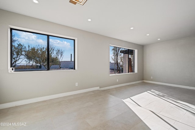 tiled spare room featuring a wealth of natural light