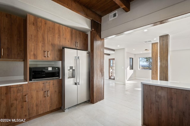 kitchen with beamed ceiling and stainless steel appliances