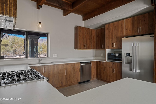 kitchen featuring sink, wooden ceiling, stainless steel appliances, beamed ceiling, and decorative light fixtures