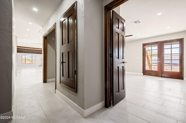 hallway with french doors and plenty of natural light