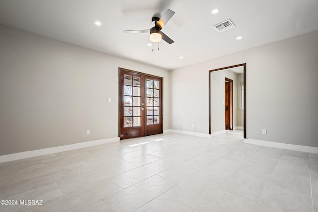 spare room featuring ceiling fan and french doors