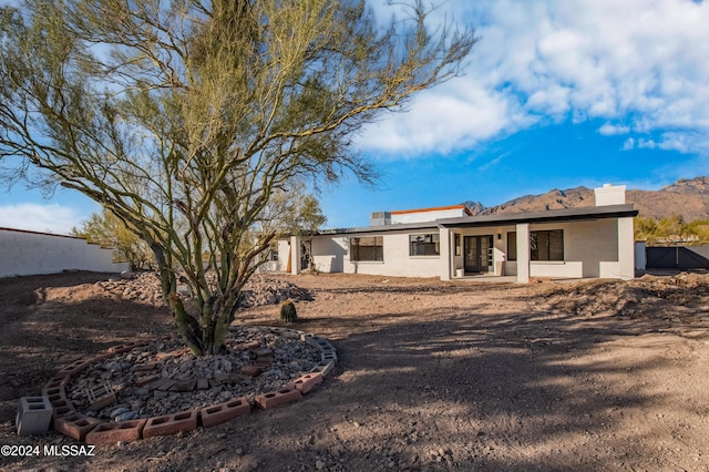 back of property with a mountain view