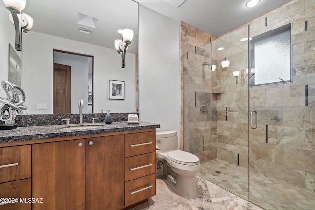 bathroom with vanity, toilet, and walk in shower