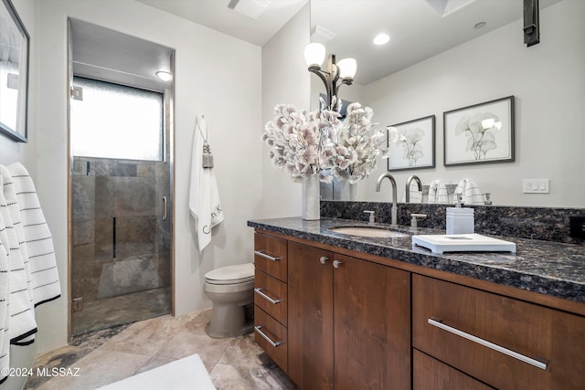 bathroom featuring vanity, toilet, and an enclosed shower