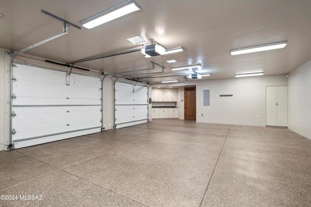 garage featuring electric panel and a garage door opener