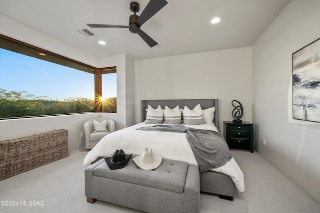 bedroom with ceiling fan and light carpet