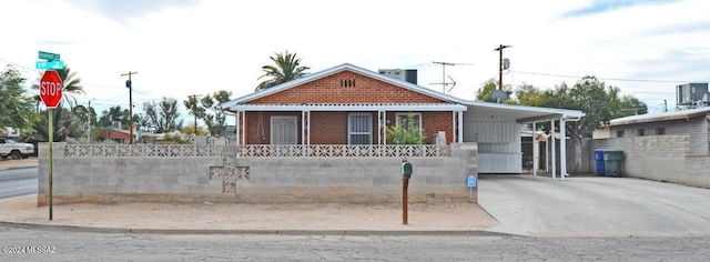 view of front of home with a carport and cooling unit