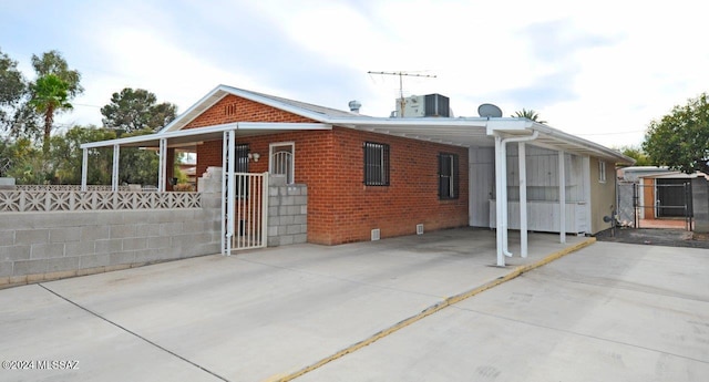 rear view of house featuring a carport