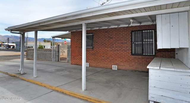 view of patio / terrace featuring a mountain view and a carport