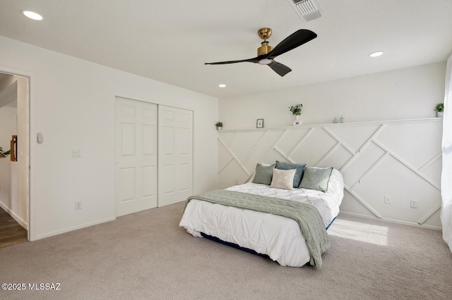 carpeted bedroom with ceiling fan, a closet, visible vents, and recessed lighting