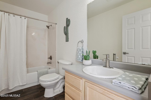 full bath featuring wood finish floors, shower / bath combo, vanity, and toilet