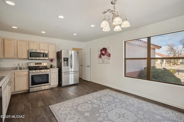 kitchen with stainless steel appliances, dark wood-type flooring, visible vents, light countertops, and light brown cabinetry