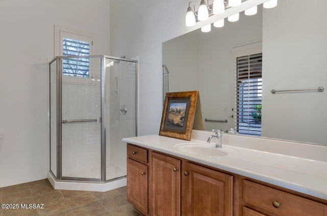 bathroom featuring vanity, a shower with door, and a healthy amount of sunlight