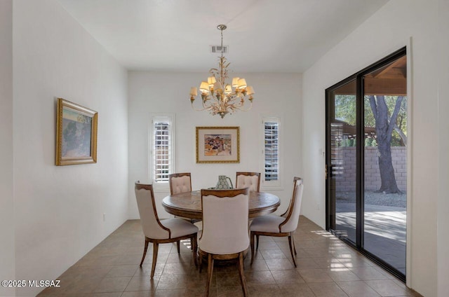 dining space with an inviting chandelier and light tile patterned floors