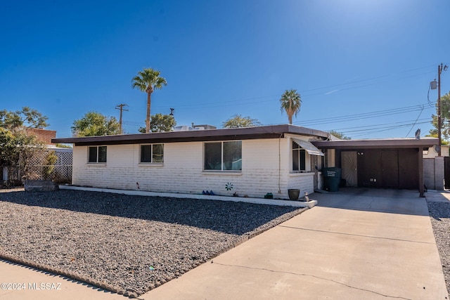 ranch-style home featuring a carport