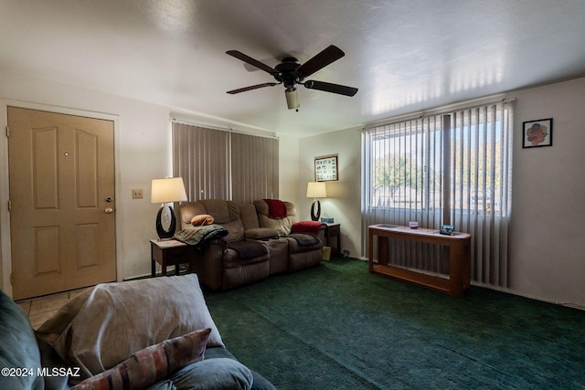 carpeted living room with ceiling fan