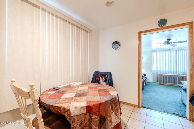 tiled dining space with ceiling fan