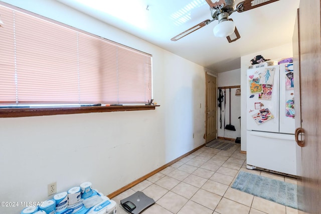 kitchen with ceiling fan, white fridge, and light tile patterned flooring