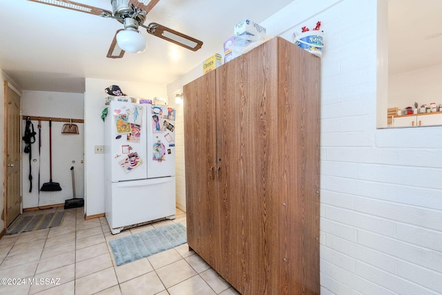 kitchen with ceiling fan, white fridge, and light tile patterned flooring